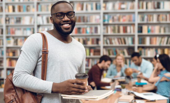 Student in library with other students in background
