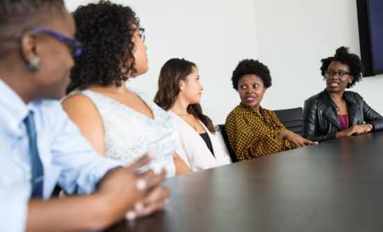Five people in a row having a discussion