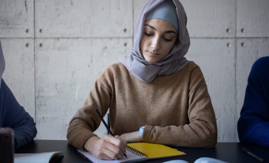 Woman making notes in notebook