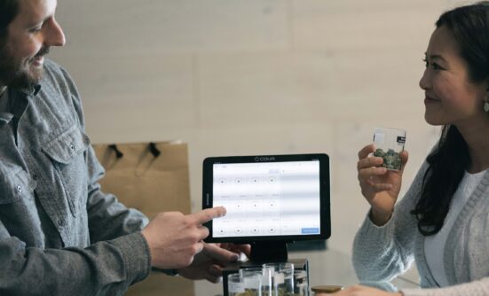 A man showing a woman display on a tablet