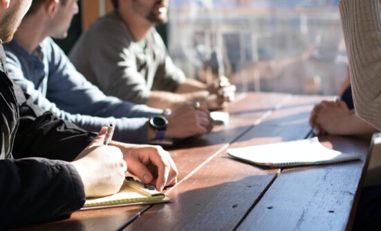 People sitting around a table discussing documents