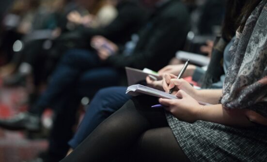 Conference delegates making notes