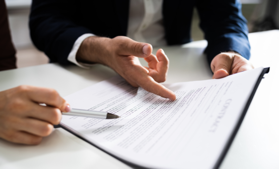 Hands pointing at a legal document