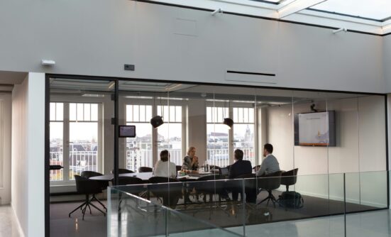 Image of a board or business meeting in a modern office.